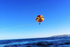 Para ludzi uprawiających parasailing nad wodą